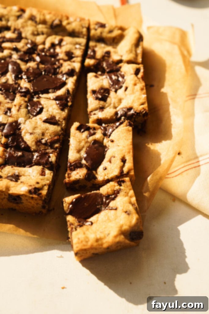 Blondie bars cut into squares on a cooling rack