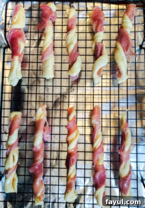 Prep image of unbaked breadsticks on rack.