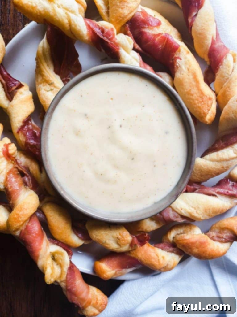 Overhead shot of breadsticks and cheese on a white plate.