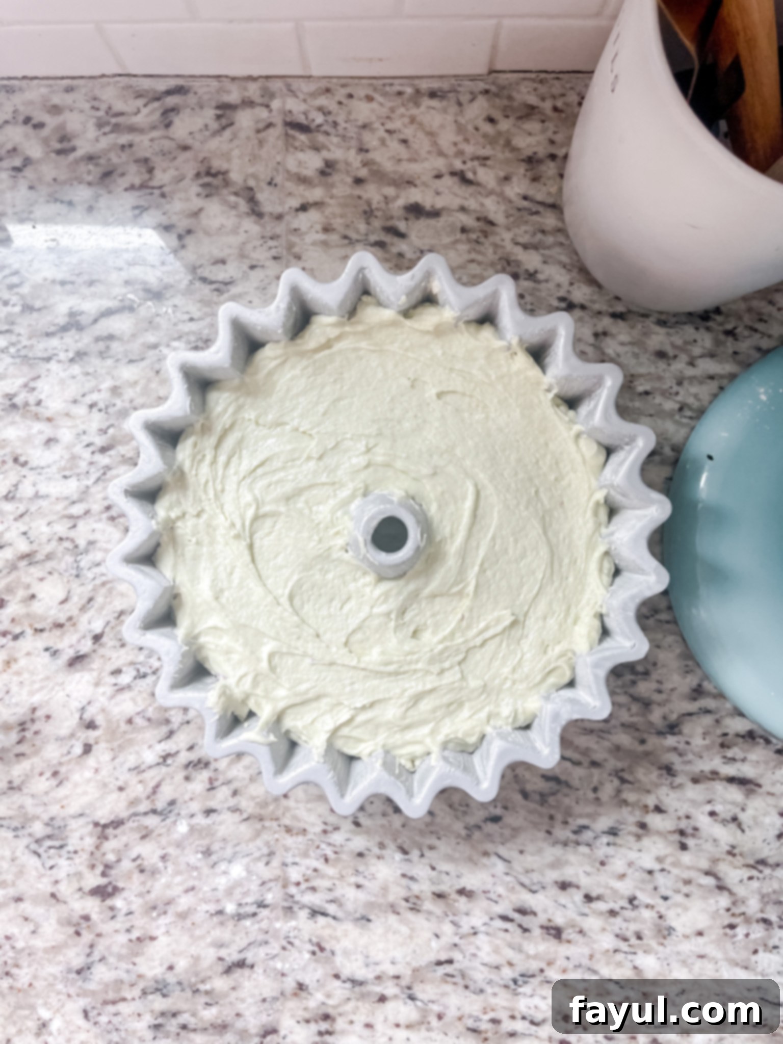 Wet ingredients being mixed together in a stand mixer, creating a light and fluffy batter.