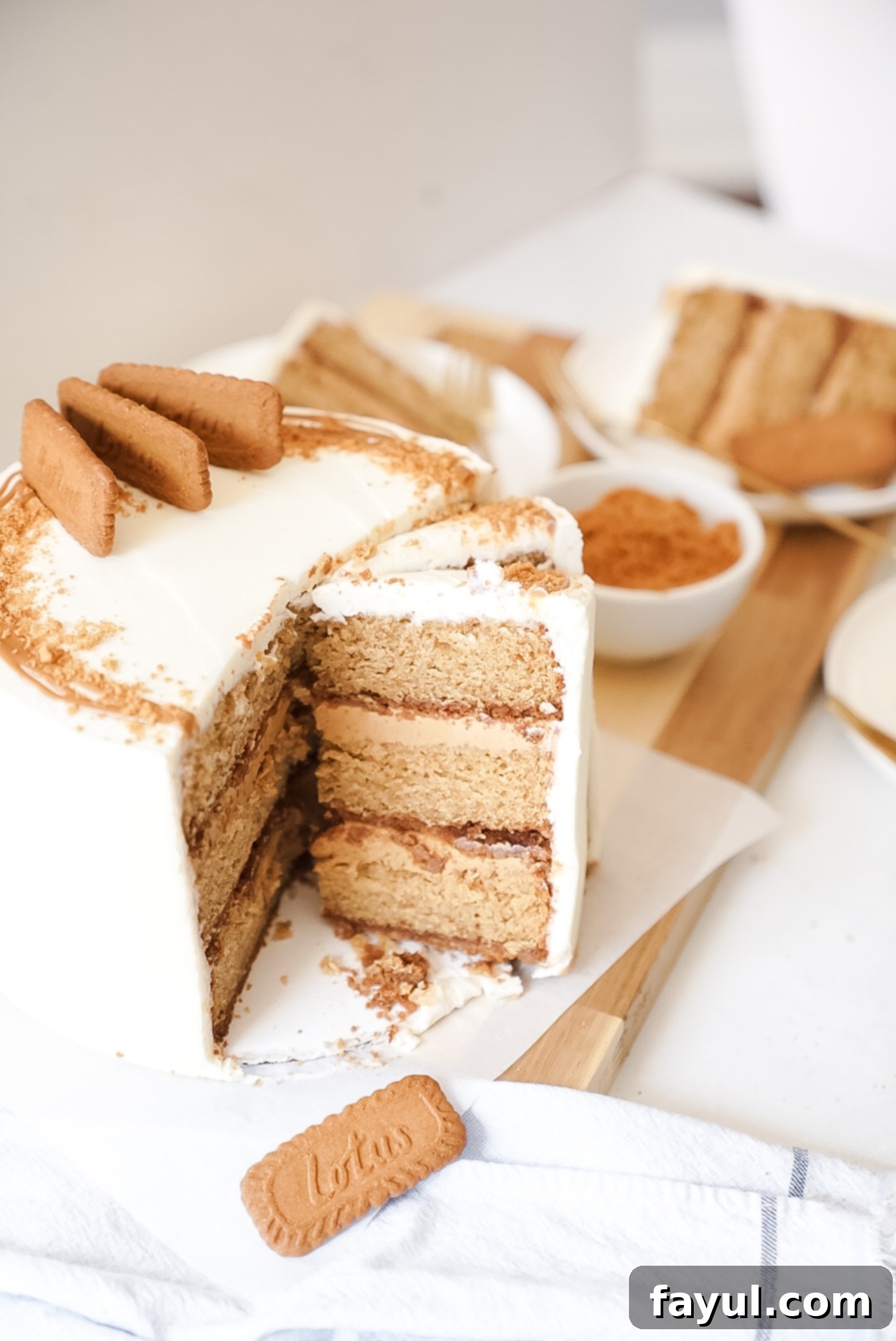 Close-up of the Biscoff cake showing the creamy filling and a sprinkle of cookie crumbs