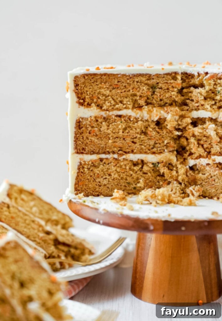 Close-up of a slice of layered brown butter carrot cake with cream cheese frosting