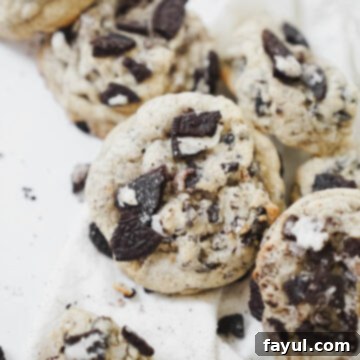 A close-up of a stack of bakery-style Oreo chocolate chip cookies, highlighting their delicious texture and ingredients.