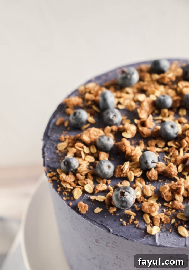 Homemade blueberry compote simmering in a saucepan, showing its thickening texture.