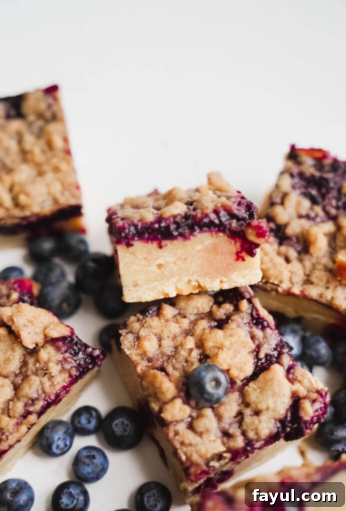 Stacked Blueberry Crisp Blondies on a plate.