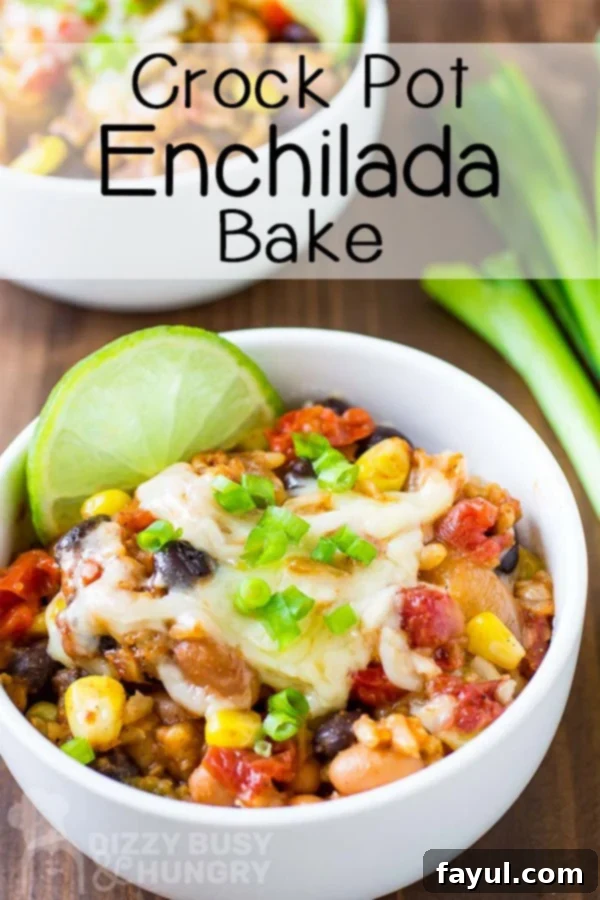 Side view of a delicious enchilada bake, garnished with a fresh lime wedge, served in a pristine white bowl.