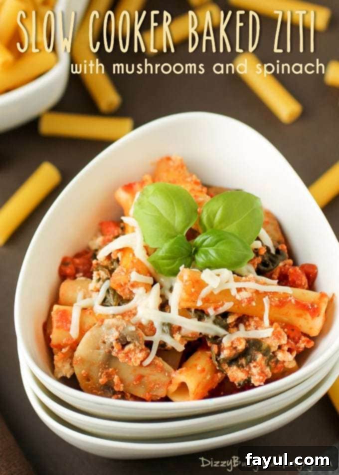 Close-up view of a perfectly cooked slow cooker baked ziti, garnished with fresh herbs, served invitingly in a white bowl.