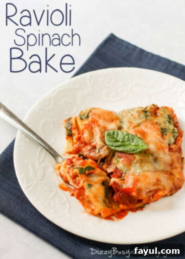 Side view of a delectable ravioli spinach bake, beautifully topped with fresh basil, served on a white plate with a fork.