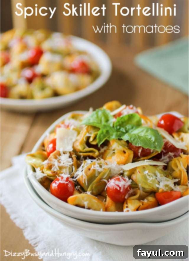 Side view of a vibrant spicy skillet tortellini dish served in a white bowl, elegantly garnished with fresh herbs.