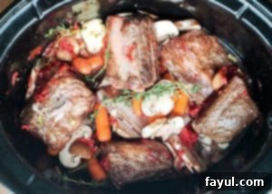 Prep image for crockpot beef short ribs recipe. Image is shot from above and shows all ingredients in a crockpot uncooked.