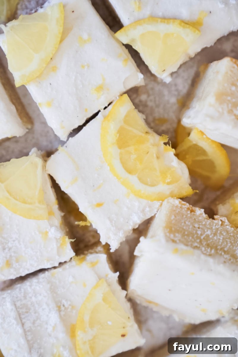 Lemon cookie bar sliced and ready to serve, showing the chewy base