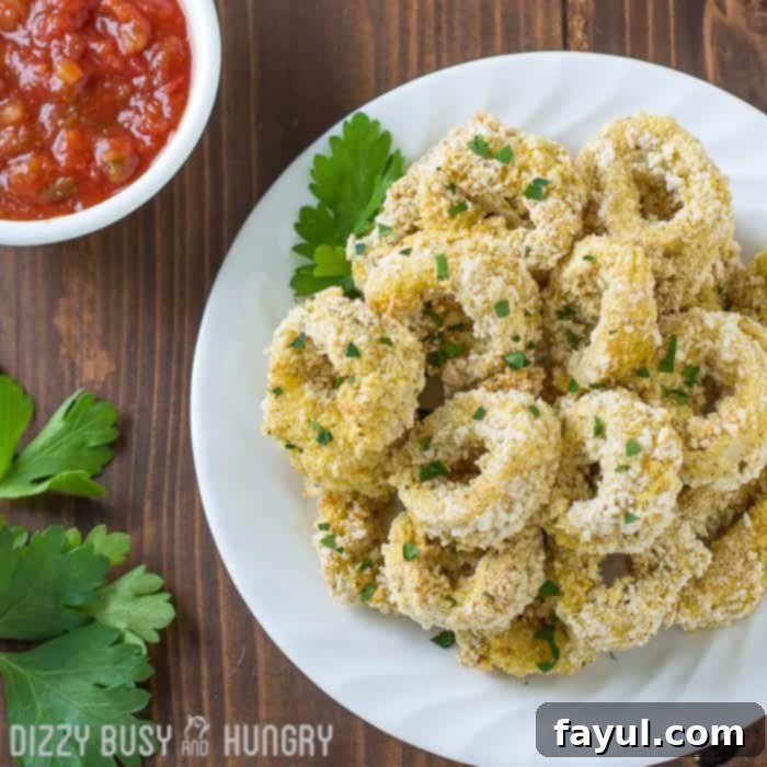 Overhead view of a plate of calamari, one of the easy seafood recipes, garnished with parsley