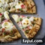 Overhead close up of sliced crab pizza on a metal pan.