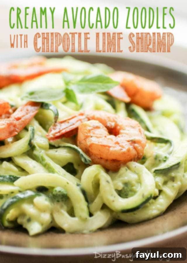 Close up view of cooked shrimp on a bed of avocado zoodles.