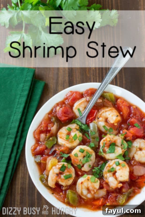 Overhead view of an easy seafood recipe: shrimp in a tomato-based stew in a white bowl with a green napkin