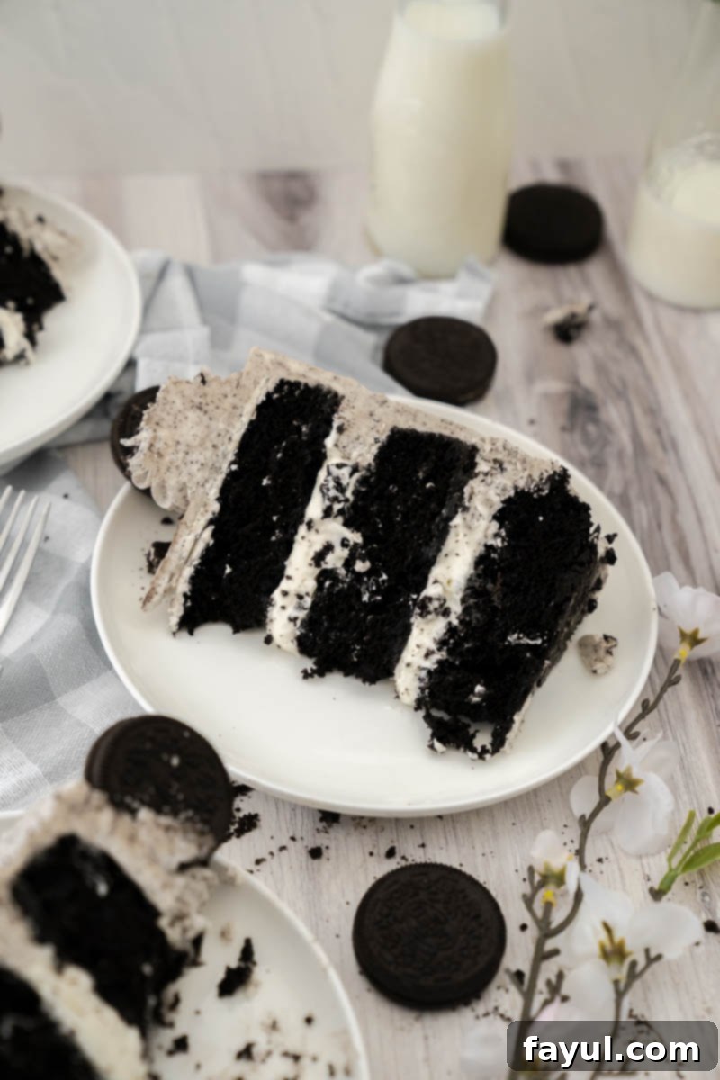 A close-up photo emphasizing the smooth, rich texture of the Oreo buttercream frosting on the cake, with visible cookie crumbs.