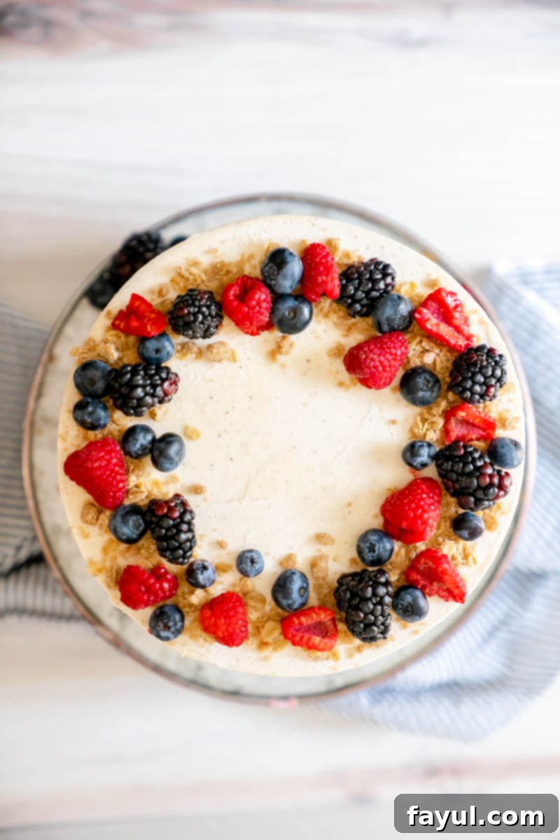 A close-up of the assembled Triple Berry Cake with the crumb coat applied.