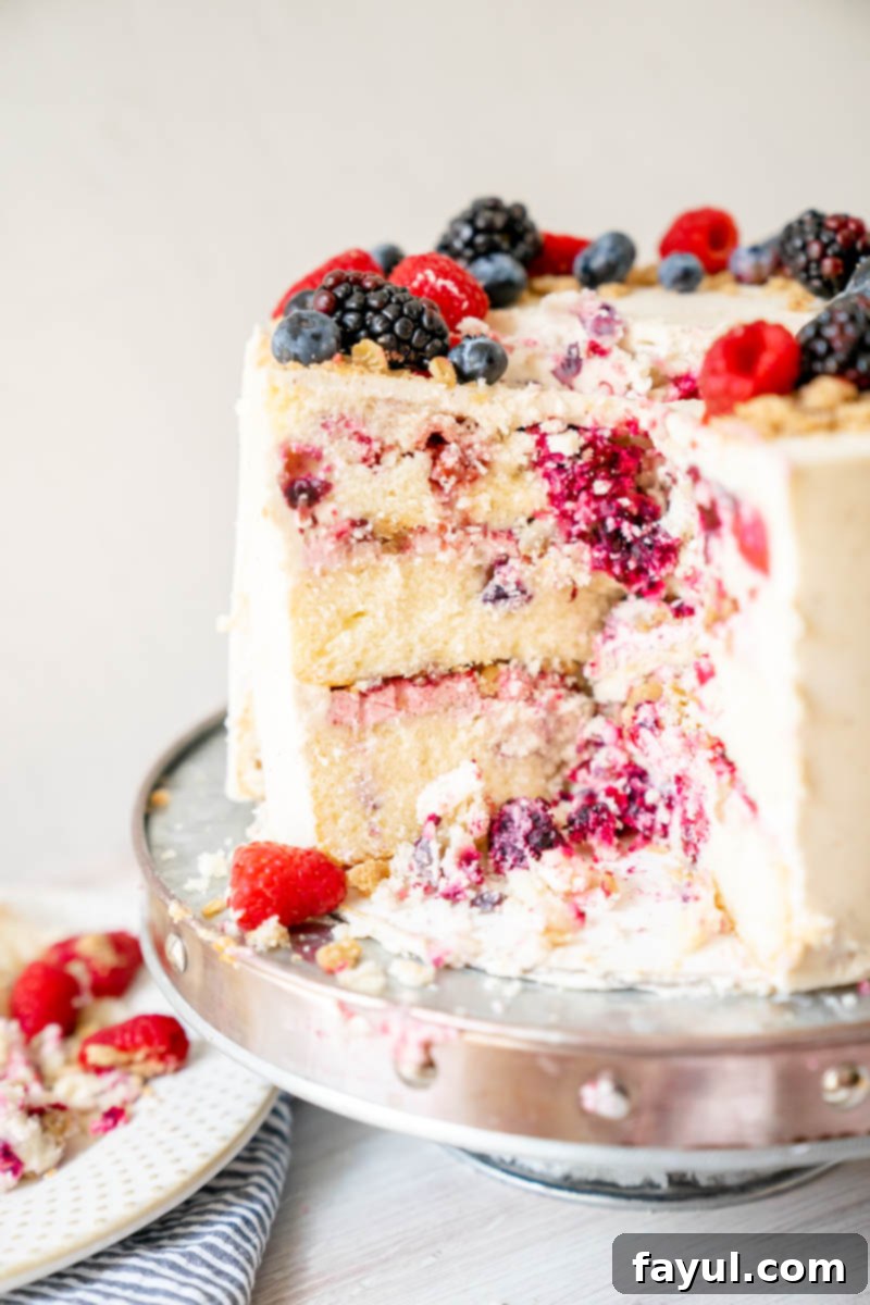 Close-up of the interior layers of the Triple Berry Cake, featuring blueberries, raspberries, and blackberries.