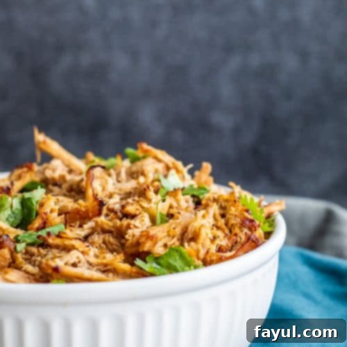 Large white bowl filled with shredded pork.