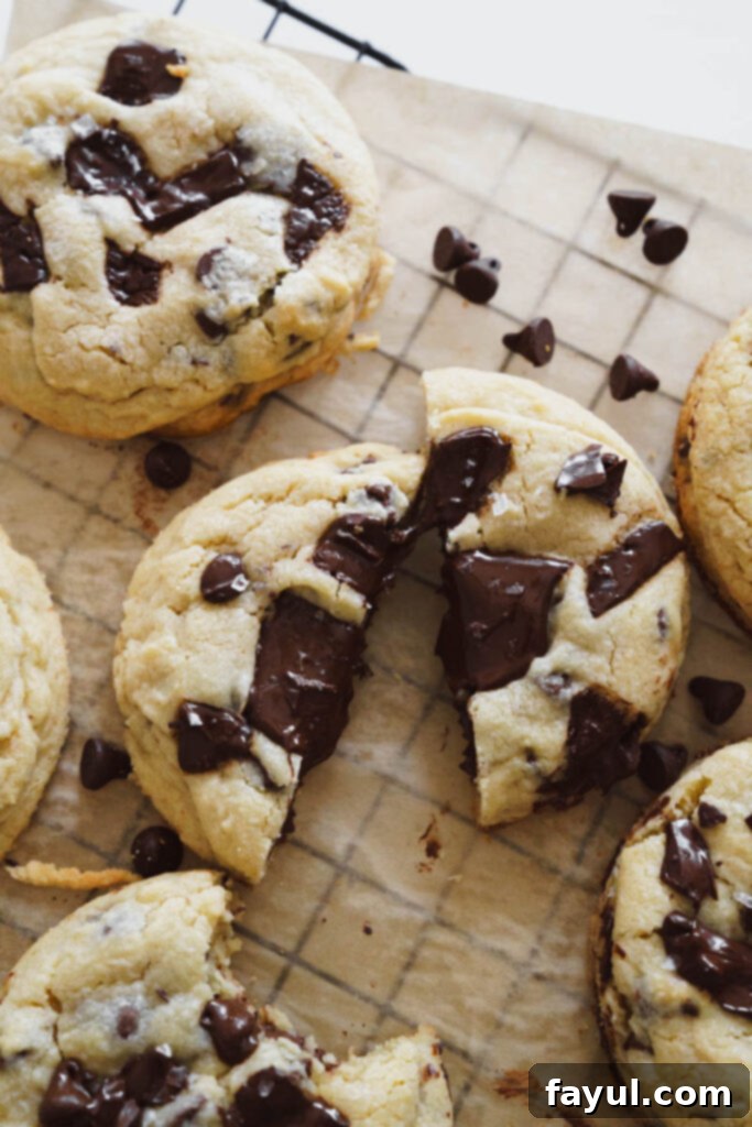 Raw chocolate chip cookie dough balls with chocolate chunks on top, ready for baking