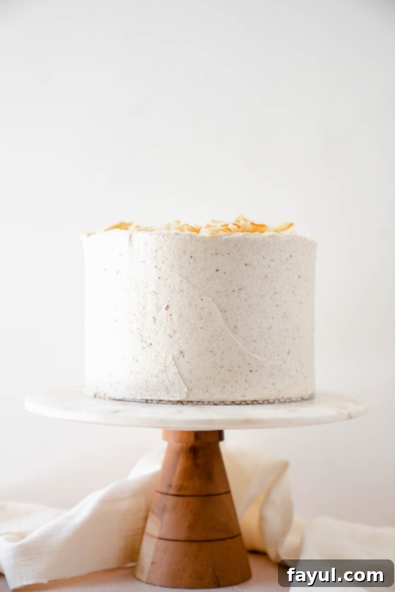 A top-down view of the Coconut Caramel Pecan Cake, highlighting the texture of the frosting and garnishes.