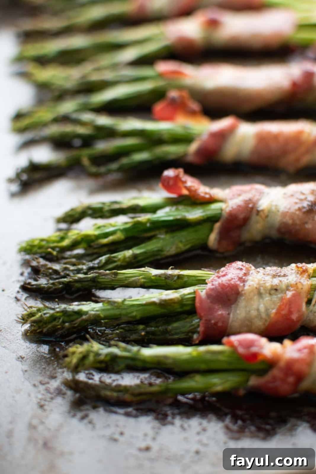 Perfectly roasted asparagus wrapped in crispy bacon, served as an elegant side dish.