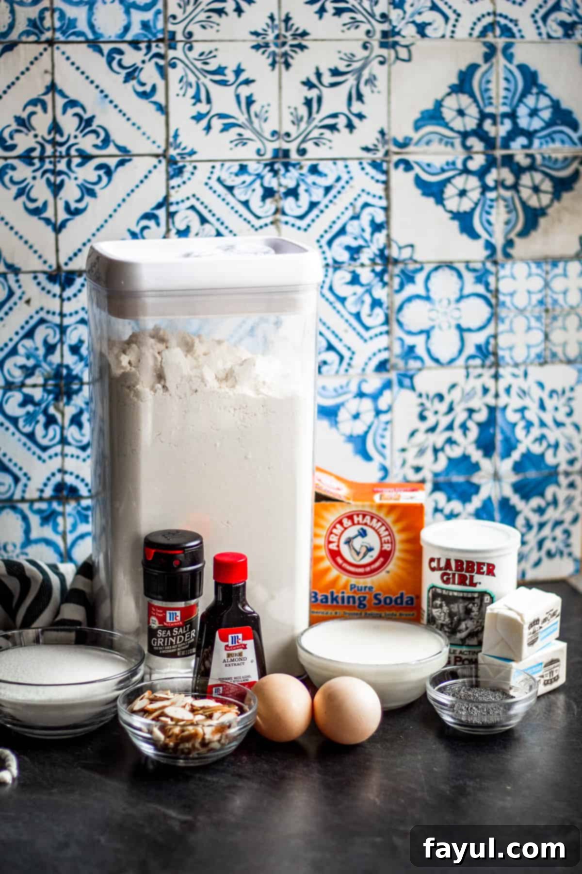 Muffin ingredients laid out on dark counter top.