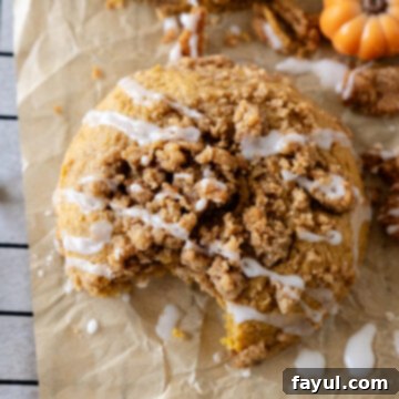 Pumpkin Coffee Cake Cookies with streusel and icing on a white plate