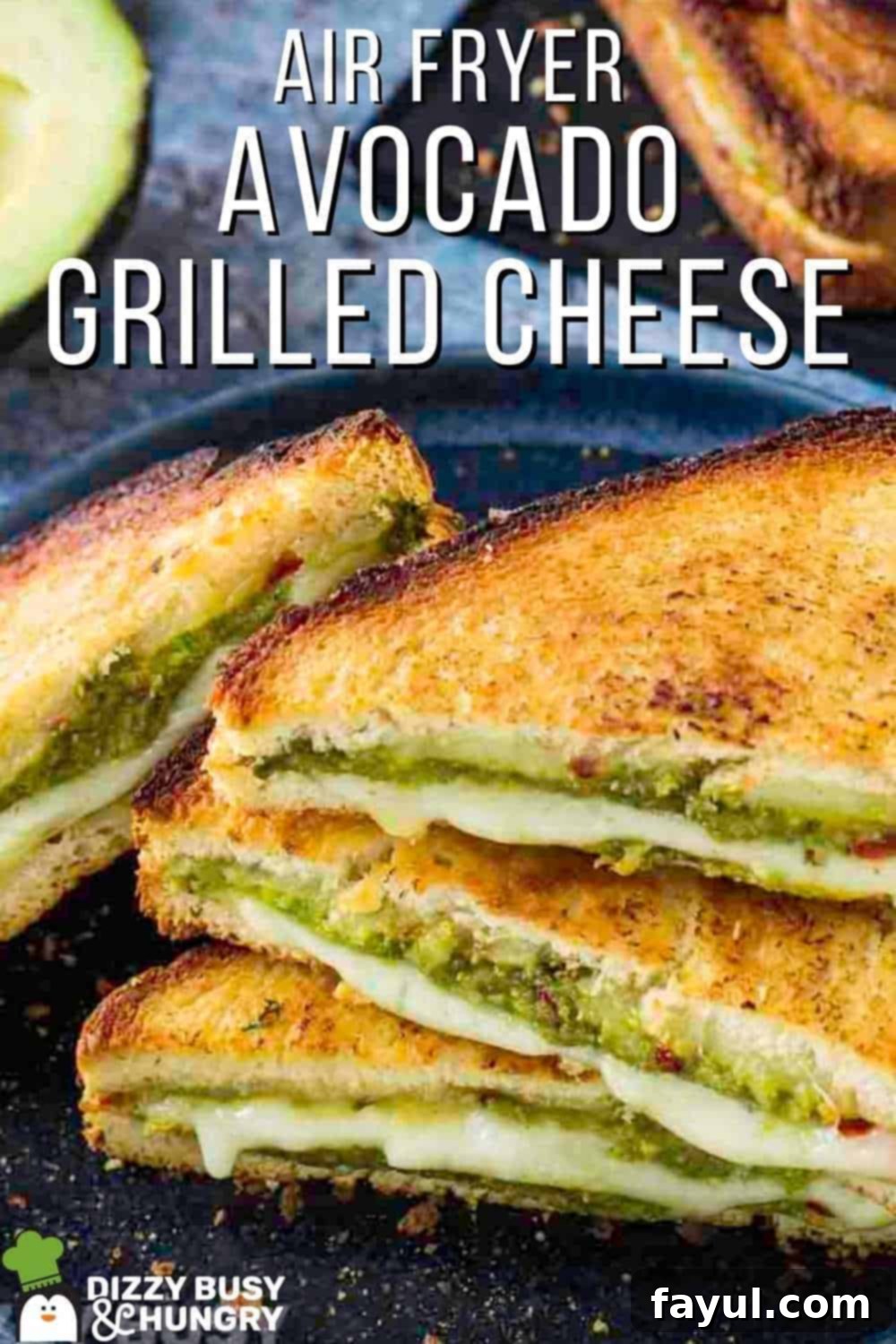 Side close up shot of multiple triangle halves of avocado grilled cheese stacked on a black plate with an avocado in the background.