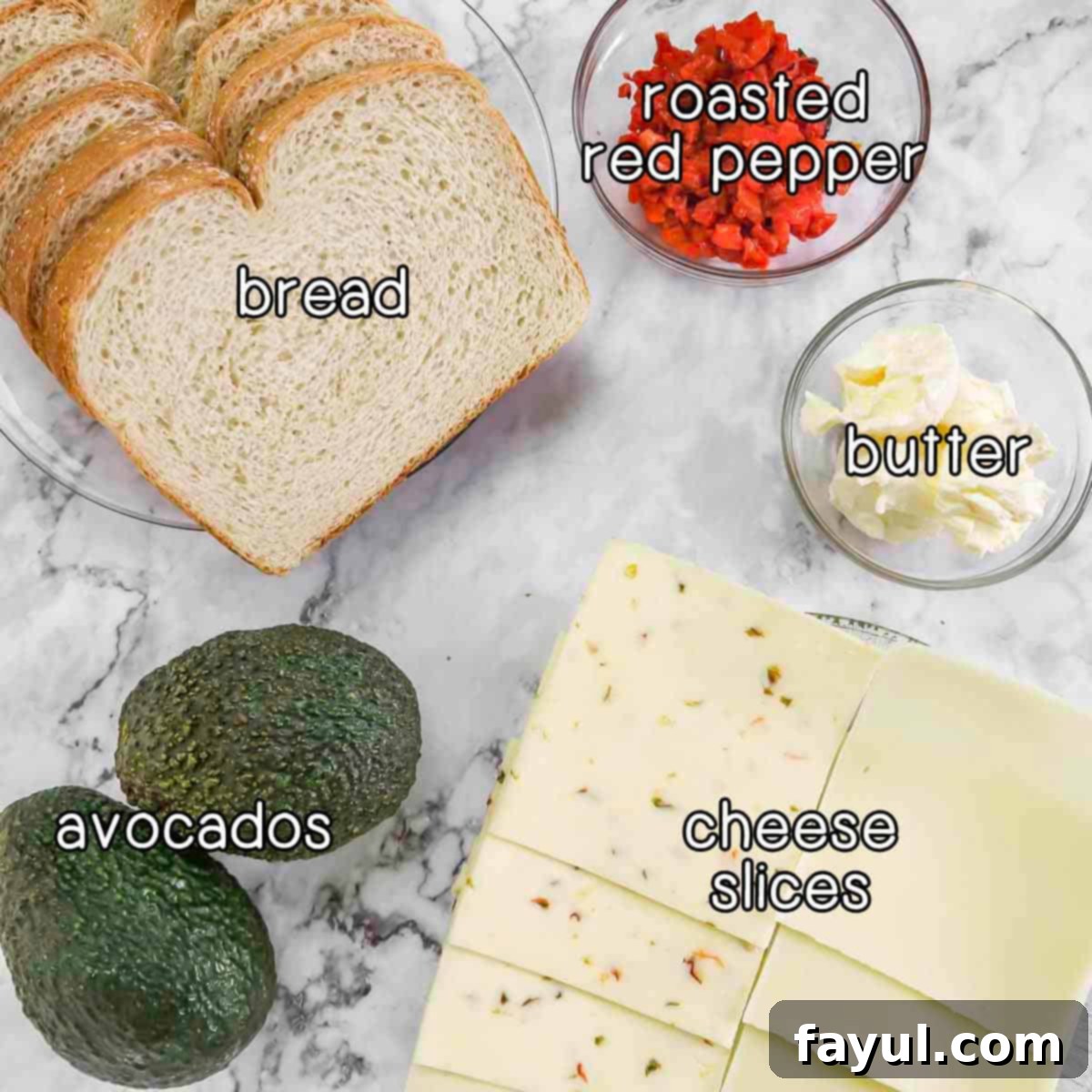 Overhead shot of ingredients- bread, roasted red pepper, butter, cheese slices, and avocados.