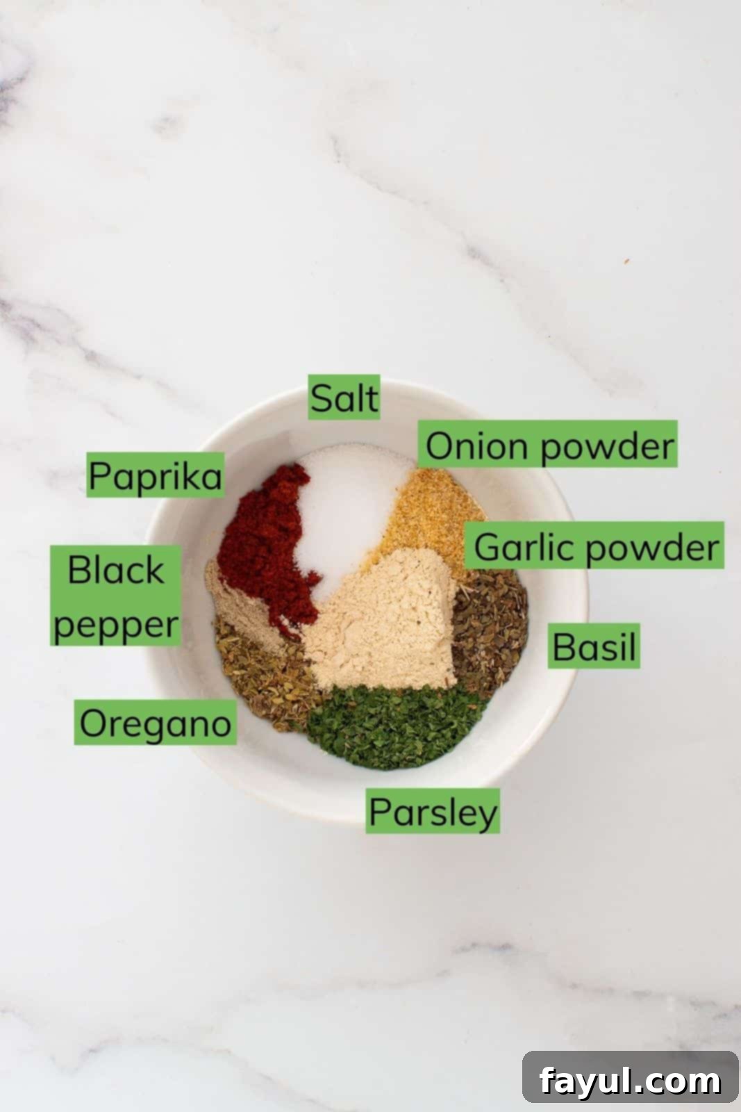 A bowl of fresh ingredients for French fry seasoning, including various spices.