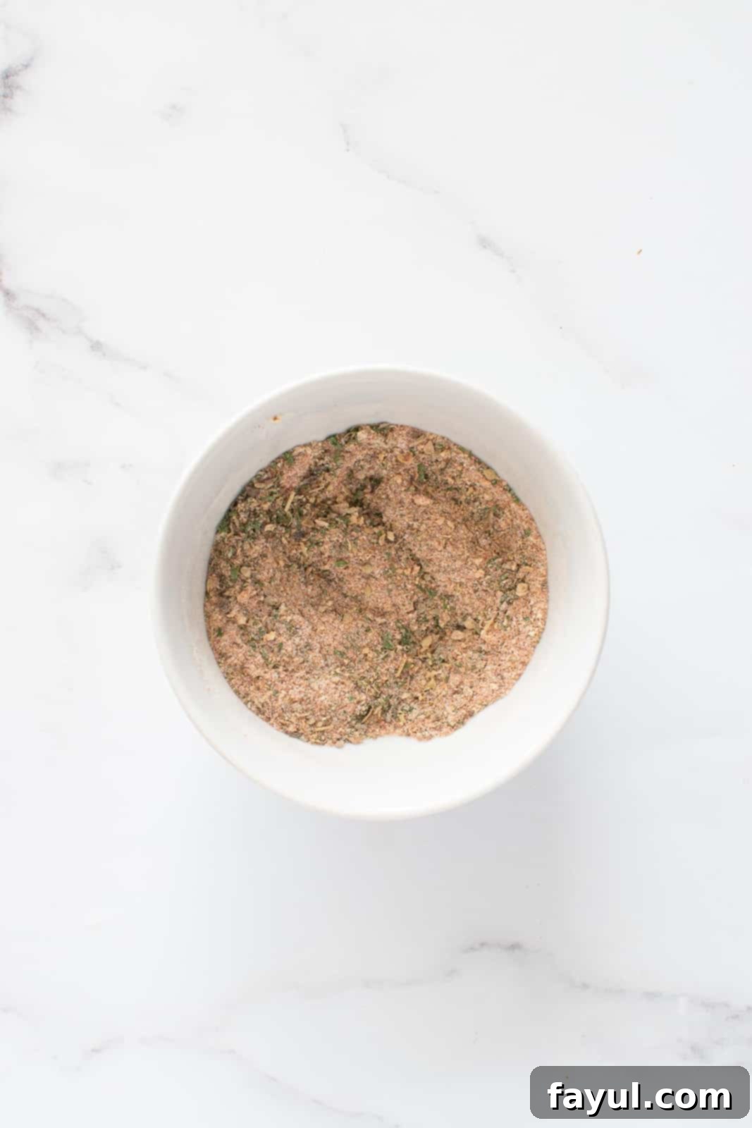 A bowl of freshly mixed homemade French fry seasoning, ready to be used.