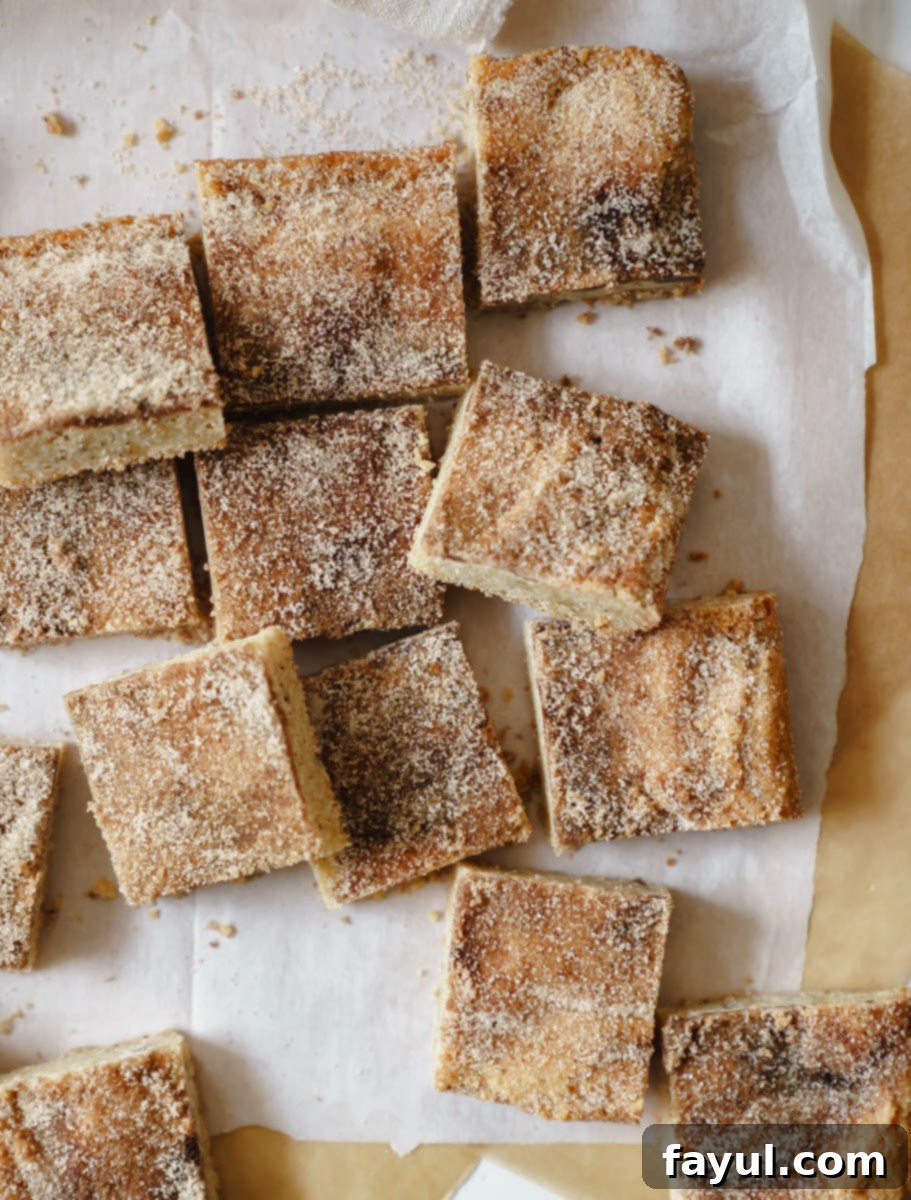 Close-up of a perfectly baked Brown Butter Snickerdoodle Blondie, showcasing its golden-brown top and chewy texture.