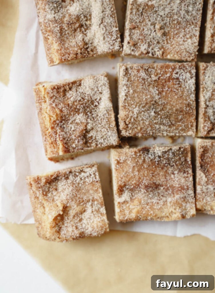 A slice of Brown Butter Snickerdoodle Blondie on a white plate with a fork.