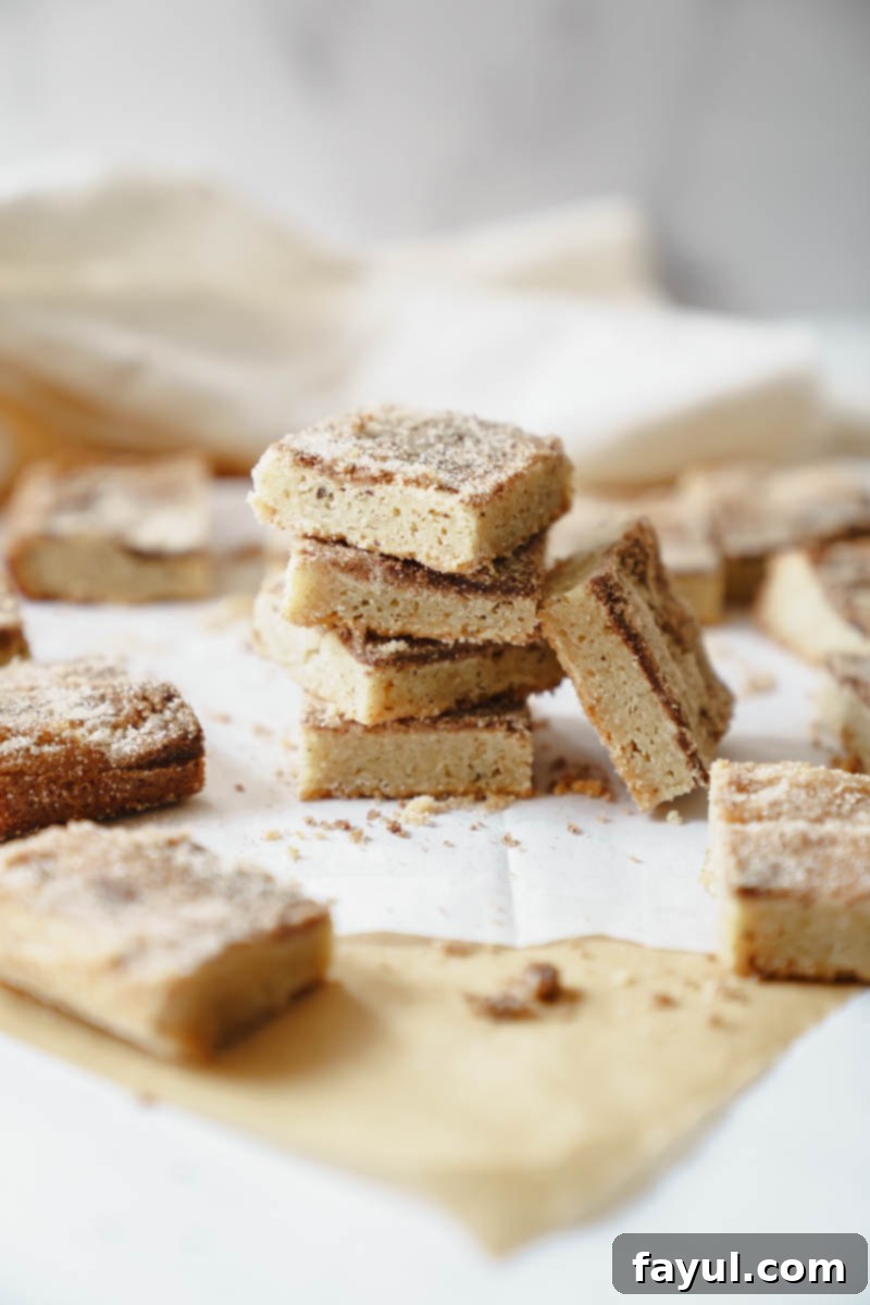 Brown Butter Snickerdoodle Blondies arranged artfully on a cooling rack.