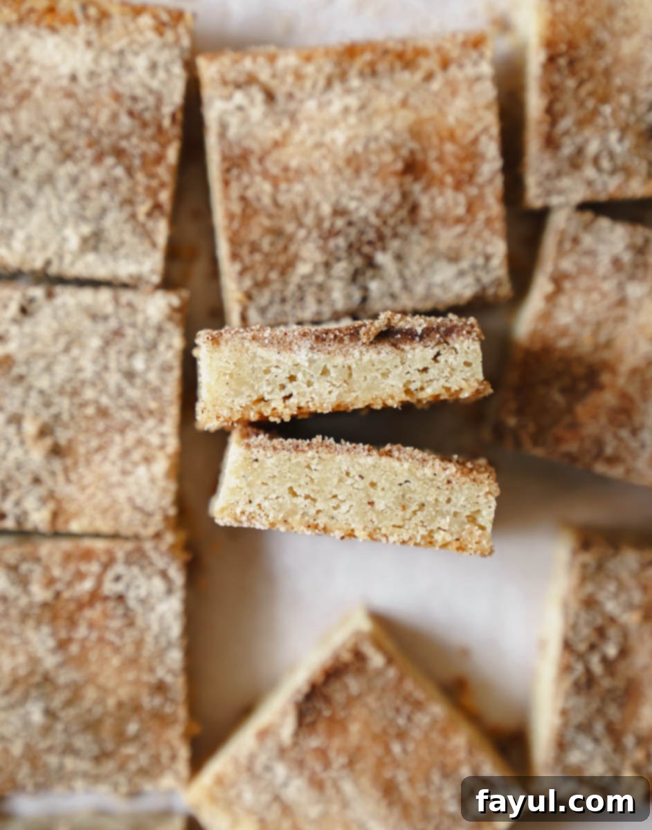 Multiple Brown Butter Snickerdoodle Blondies arranged on a white serving platter.