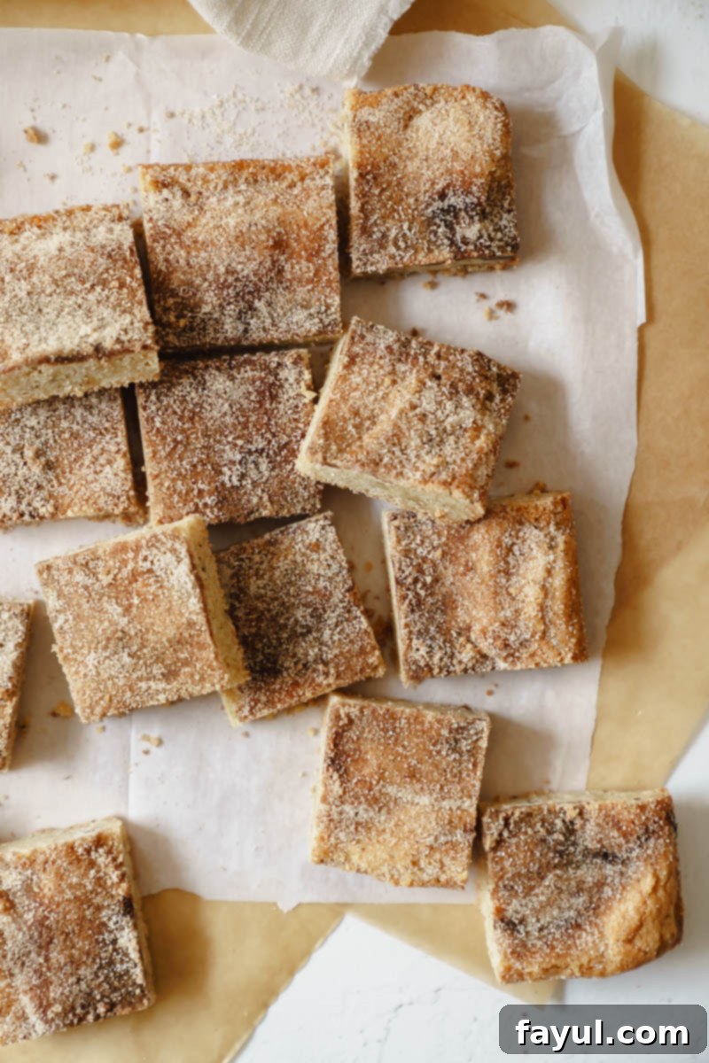 A close-up shot of a single Brown Butter Snickerdoodle Blondie piece, emphasizing its texture and topping.