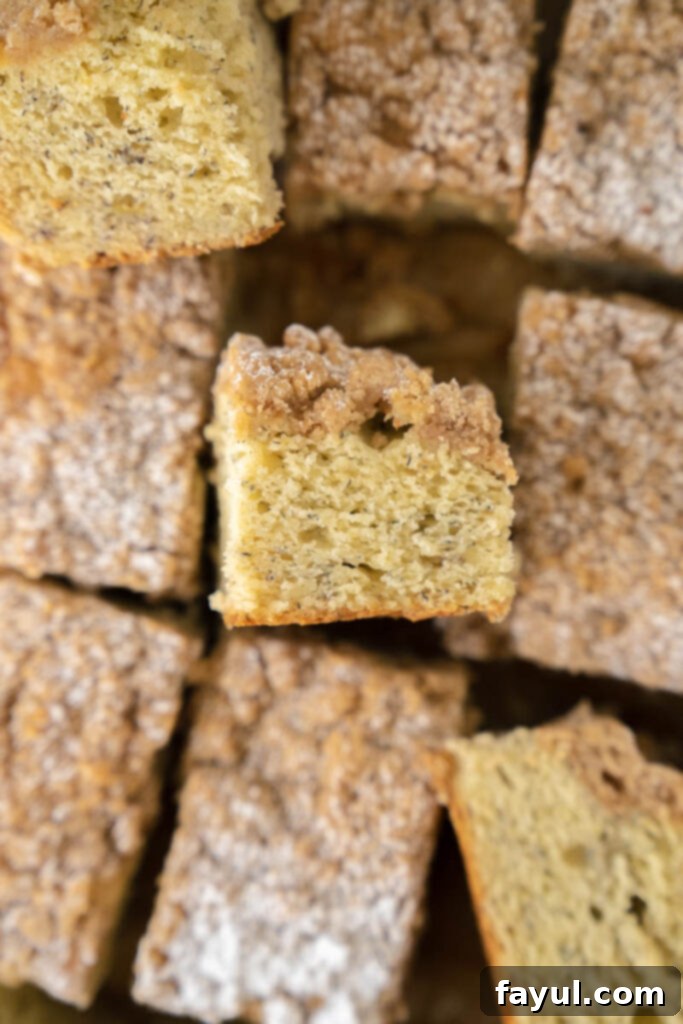 Close up of a slice of Banana Coffee Sheet Cake showing the moist interior and streusel topping