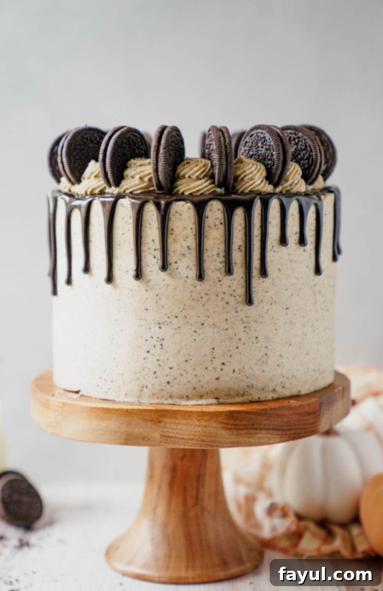 Pumpkin Oreo Cake being frosted with buttercream