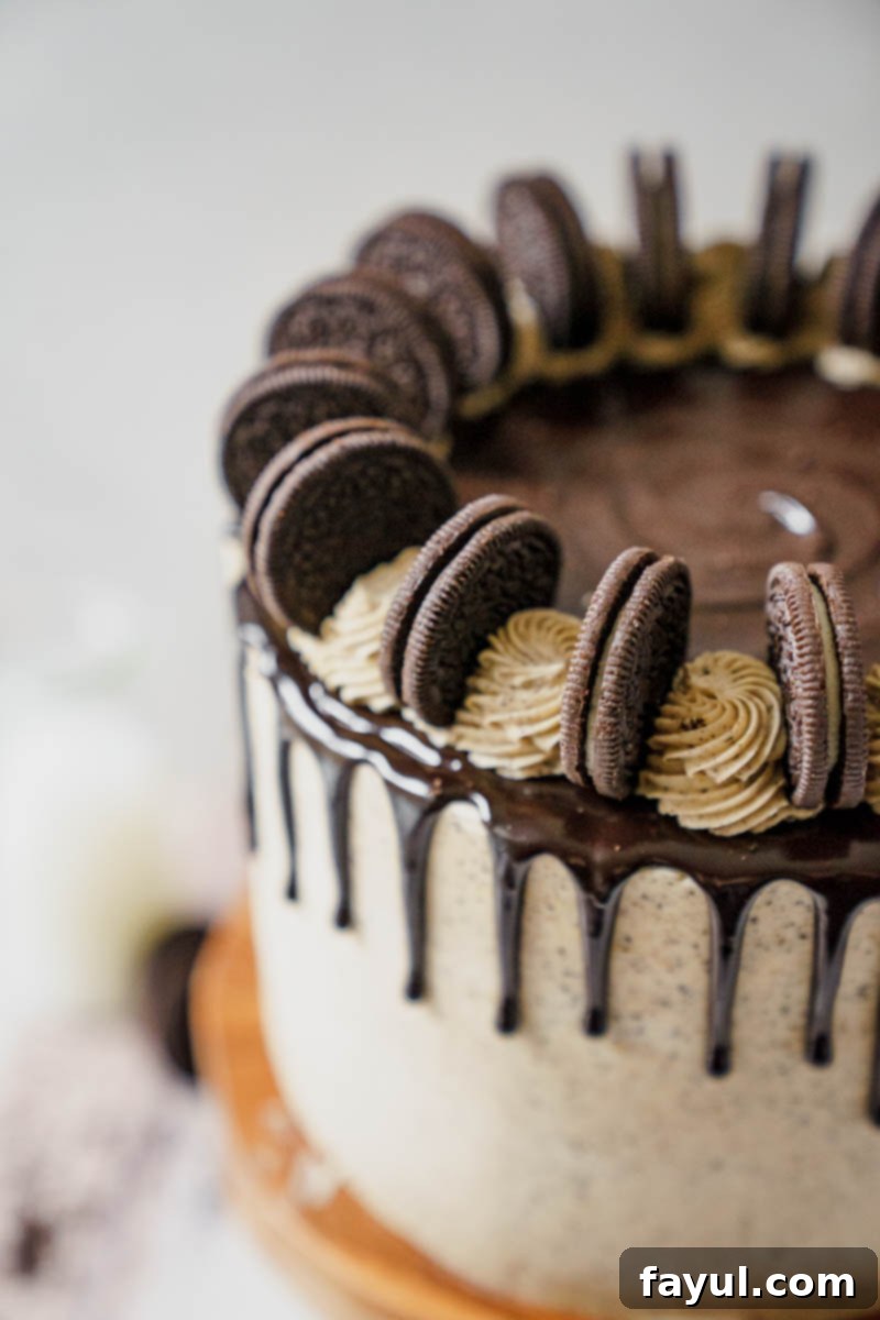 Pumpkin Oreo Cake slice on a plate with crushed Oreos