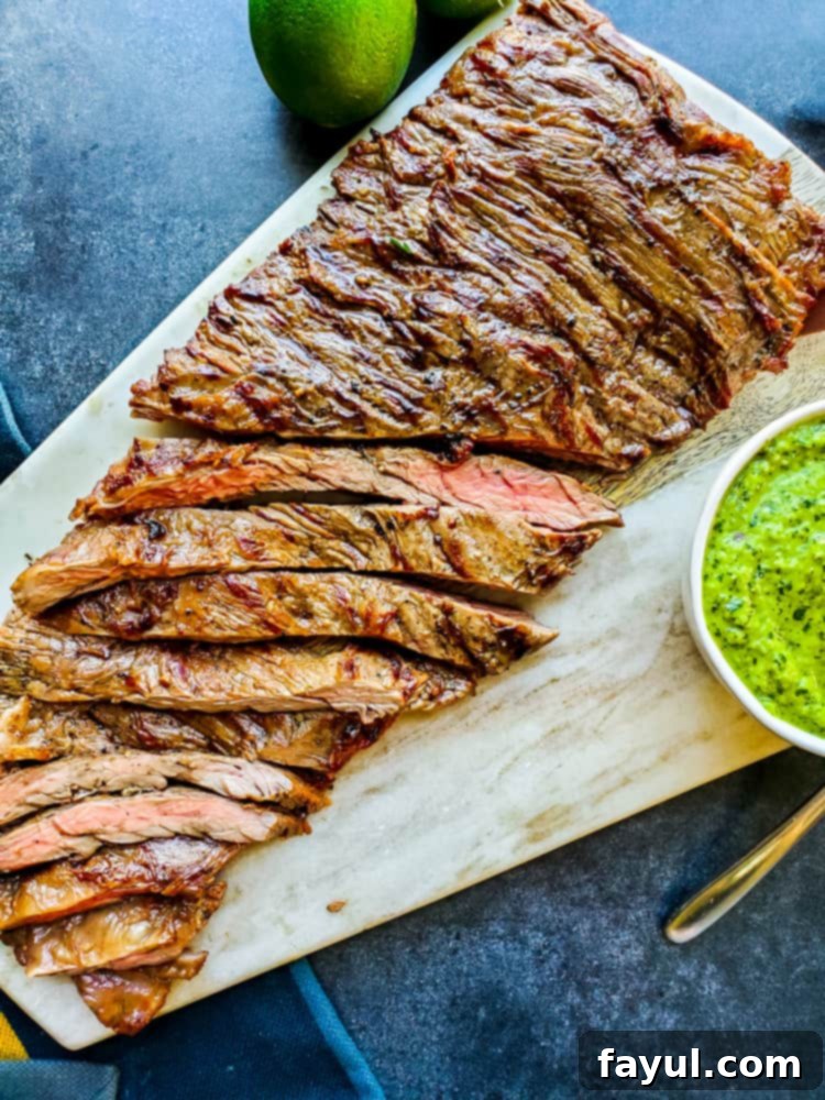 Overhead shot of skirt steak cut on cutting board.