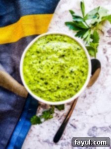 Easy Homemade Chimichurri Sauce: Perfect for Grilling, Marinating, and Dipping. Healthy, Vegan, Gluten-Free, Low-Carb, Whole30, Keto, and Paleo friendly! This Easy Chimichurri Sauce recipe is the best for grilled meats, veggies, as a marinade, or a dip! This traditional Argentinian sauce is ready in only five minutes and made with cilantro, parsley, olive oil, spices, and garlic. Also this sauce is naturally healthy, vegan, gluten-free, low-carb, Whole30, keto, and paleo. #sauce #chimichurri #easyrecipe #vegan #grilling