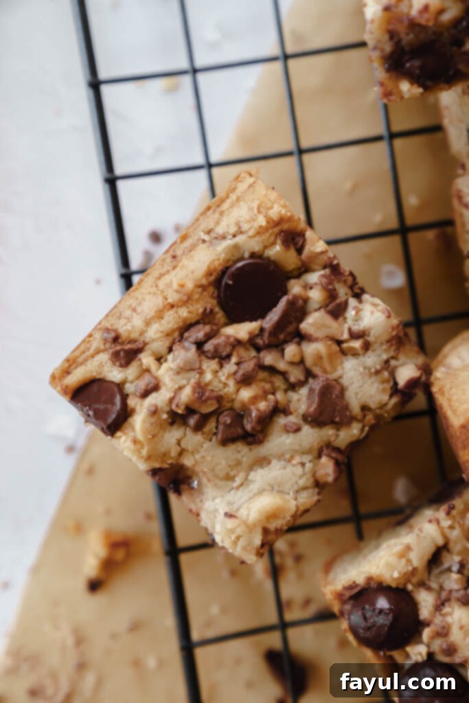 Close-up of a Dark Chocolate Toffee Blondie revealing toffee bits and chocolate chips.