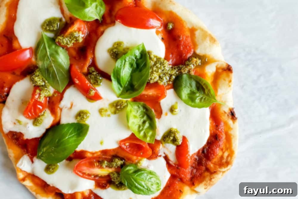 15-Minute Naan Margherita Pizza Hack 2 Overhead shot of pizza on parchment paper.