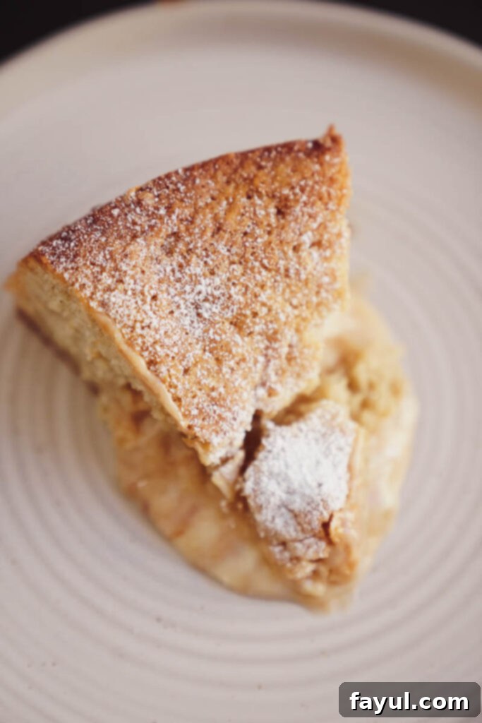 Decorated brown butter pear cake with caramel and powdered sugar
