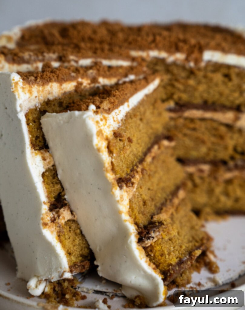 Decorated pumpkin biscoff cake with white chocolate frosting and cookie crumbs on top