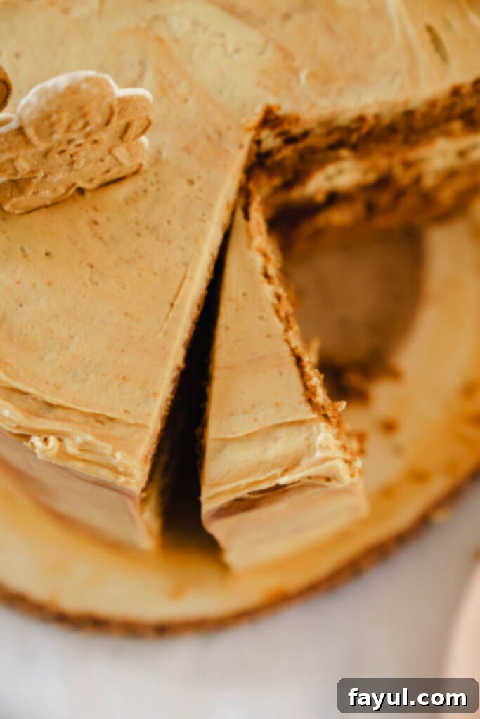 Close-up of caramel being drizzled over gingerbread cake layers.