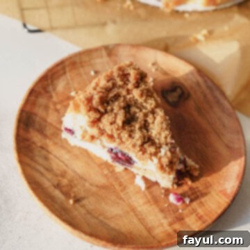 Close-up of a baked Blueberry Buckle Cake with a fork, showing the moist interior