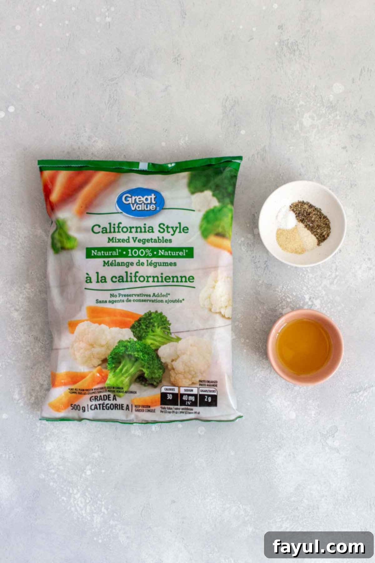 Ingredients laid out on a counter, including a bag of frozen vegetables, olive oil, and various spices.