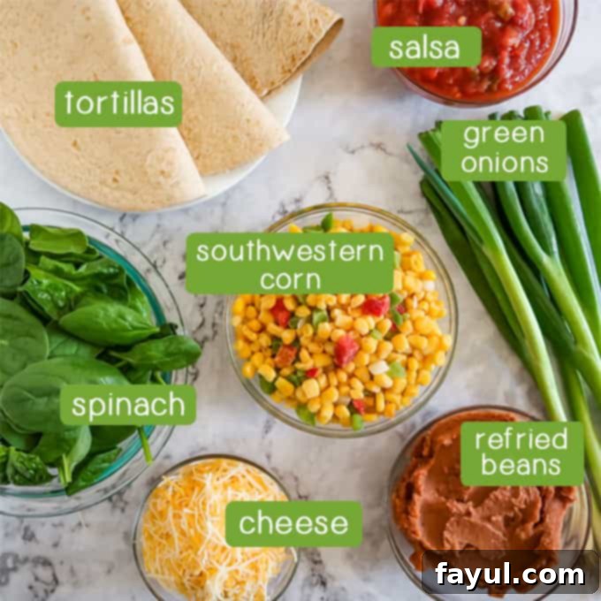 Overhead shot of all the simple ingredients required for the vegetarian Mexican lasagna: whole wheat tortillas, chunky salsa, fresh green onions, baby spinach, frozen southwestern corn blend, a can of refried beans, and shredded fiesta blend cheese.